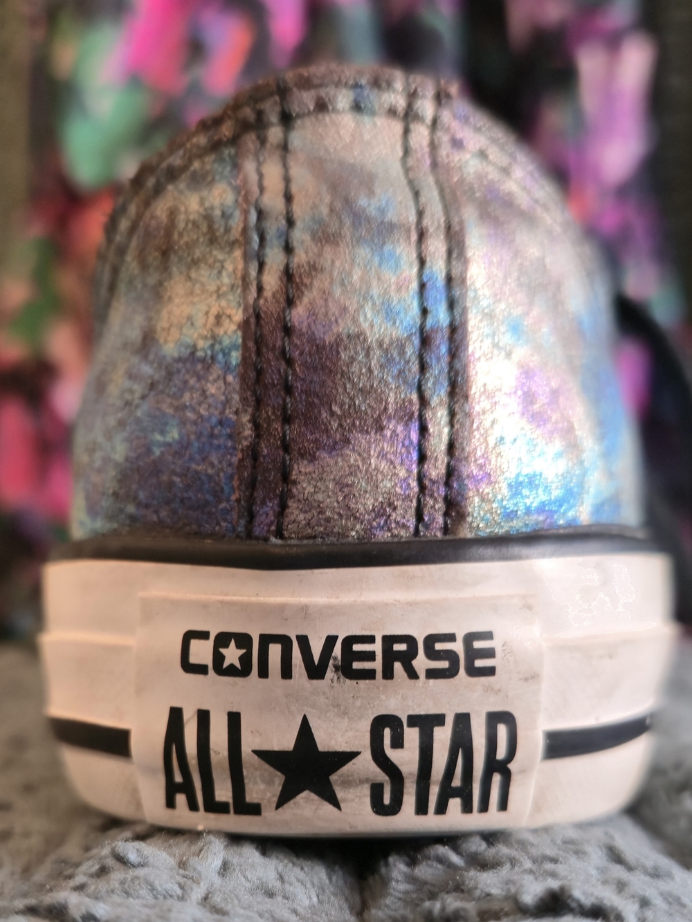 Converse Chuck Taylor All Star Ox low-top sneakers featuring an iridescent, oil-